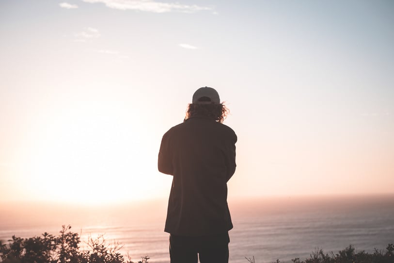 Anonymous man contemplating on sunset seascape