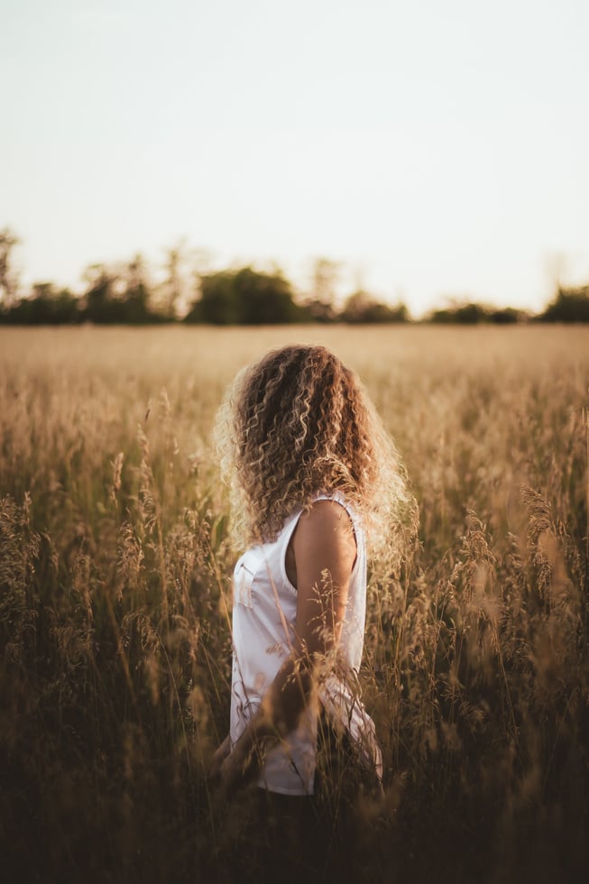 Anonymous woman in grassy meadow